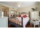 Guest bedroom with queen bed, hardwood floors, and ceiling fan at 8989 N Gainey Center Dr # 114, Scottsdale, AZ 85258