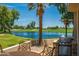 Relaxing patio with a golf course view, featuring a built-in grill and seating area at 8989 N Gainey Center Dr # 114, Scottsdale, AZ 85258