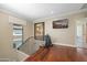 Upstairs hallway with hardwood floors, artwork, and home gym area at 8989 N Gainey Center Dr # 114, Scottsdale, AZ 85258