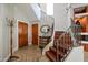 Elegant entryway with wood staircase, tile flooring, and coat rack at 8989 N Gainey Center Dr # 114, Scottsdale, AZ 85258