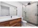 Modern bathroom with a walk-in shower, floating vanity, and wood cabinets at 18416 N Cave Creek Rd # 2037, Phoenix, AZ 85032