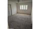 Large carpeted bedroom with a window and sliding door at 10617 W Deanne Dr, Sun City, AZ 85351