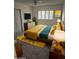 Spacious bedroom with mid-century modern furniture and a large window at 10617 W Deanne Dr, Sun City, AZ 85351