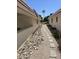 Stone pathway between buildings with gravel landscaping at 10617 W Deanne Dr, Sun City, AZ 85351