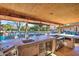 Outdoor kitchen overlooking a pool and backyard at 6614 W Sweetwater Ave, Glendale, AZ 85304