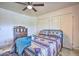 Bedroom with queen bed, dresser, and ceiling fan at 6614 W Sweetwater Ave, Glendale, AZ 85304