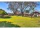 Large backyard with lush lawn and mature trees at 6614 W Sweetwater Ave, Glendale, AZ 85304