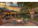 Relaxing patio with fire pit and hot tub at 6614 W Sweetwater Ave, Glendale, AZ 85304