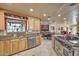 Modern kitchen with light wood cabinets, granite counters, and stainless steel appliances at 6614 W Sweetwater Ave, Glendale, AZ 85304