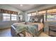 Bedroom with a rustic-style bed, nightstands, and lots of natural light at 6614 W Sweetwater Ave, Glendale, AZ 85304