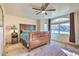 Bright bedroom with a wooden bed frame and large window at 6614 W Sweetwater Ave, Glendale, AZ 85304