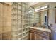 Bathroom with glass block shower and wood vanity at 6614 W Sweetwater Ave, Glendale, AZ 85304