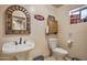 Small bathroom with pedestal sink, toilet, and Coca-Cola decor at 6614 W Sweetwater Ave, Glendale, AZ 85304