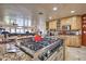 Island kitchen features a gas cooktop and granite countertops at 6614 W Sweetwater Ave, Glendale, AZ 85304