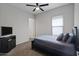 Guest bedroom with ceiling fan and double-door closet at 41758 W Cribbage Rd, Maricopa, AZ 85138