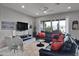 Spacious living room with leather sectional sofa and large TV at 41758 W Cribbage Rd, Maricopa, AZ 85138