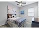 Bright bedroom with ceiling fan and ample closet space at 41758 W Cribbage Rd, Maricopa, AZ 85138
