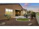 Landscaped backyard with patio, artificial turf and hot tub at 41758 W Cribbage Rd, Maricopa, AZ 85138