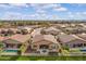 Aerial view of community with houses and green spaces at 41758 W Cribbage Rd, Maricopa, AZ 85138