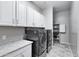 Laundry room with washer, dryer, cabinets and granite countertop at 41758 W Cribbage Rd, Maricopa, AZ 85138