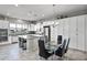 Eat-in kitchen with island, granite countertops, and white cabinets at 41758 W Cribbage Rd, Maricopa, AZ 85138