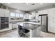 Spacious kitchen with white cabinets, granite countertops, and stainless steel appliances at 41758 W Cribbage Rd, Maricopa, AZ 85138
