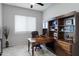 Home office with built-in wooden desk and shelving at 41758 W Cribbage Rd, Maricopa, AZ 85138
