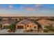 Aerial view of a single-story home in a residential community, featuring a desert landscape at 41758 W Cribbage Rd, Maricopa, AZ 85138
