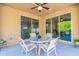 Covered patio with seating area and sliding glass doors at 13234 W Hummingbird Ter, Peoria, AZ 85383