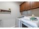 Bright laundry room with washer, dryer, and ample storage at 13234 W Hummingbird Ter, Peoria, AZ 85383