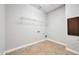 Laundry room with overhead shelving and tile flooring at 26886 N 90Th Ave, Peoria, AZ 85383