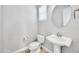 Small bathroom with pedestal sink and toilet at 26886 N 90Th Ave, Peoria, AZ 85383