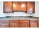 Kitchen features granite countertop and rich wood cabinetry at 26886 N 90Th Ave, Peoria, AZ 85383