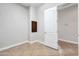 A simple hallway with neutral-toned walls and tiled flooring at 26886 N 90Th Ave, Peoria, AZ 85383