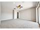 Large bedroom with carpeted flooring and access to backyard at 26886 N 90Th Ave, Peoria, AZ 85383