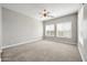 Bright bedroom with neutral walls, carpet, and two large windows at 26886 N 90Th Ave, Peoria, AZ 85383