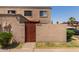 Front view of a tan stucco building with a red gate at 4025 W Palomino Rd, Phoenix, AZ 85019