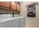 Laundry room with washer, dryer, and wood cabinets at 13013 N Panorama Dr # 128, Fountain Hills, AZ 85268