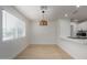 Bright dining room with light wood floors and modern light fixture at 20836 E Pickett St, Queen Creek, AZ 85142