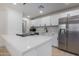 Modern kitchen with stainless steel appliances and white cabinets at 20836 E Pickett St, Queen Creek, AZ 85142