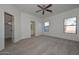 Well-lit bedroom with carpet, closet, and bathroom access at 17226 W Maui Ln, Surprise, AZ 85388