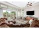 Bright living room with a brown sectional sofa and sliding glass doors at 30056 N 132Nd Dr, Peoria, AZ 85383