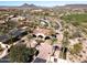 Aerial view of the community entrance with palm trees and mountains in the background at 12789 W Via Caballo Blanco --, Peoria, AZ 85383