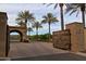 Gated community entrance with a rustic wooden gate at 12789 W Via Caballo Blanco --, Peoria, AZ 85383