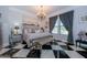 Elegant main bedroom with a king-size bed and black and white checkered floors at 12789 W Via Caballo Blanco --, Peoria, AZ 85383