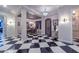 Elegant entryway with a black and white checkered floor and a chandelier at 12789 W Via Caballo Blanco --, Peoria, AZ 85383