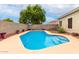 Inviting kidney-shaped pool with a spacious patio at 29759 N Desert Angel Dr, San Tan Valley, AZ 85143