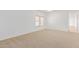 Bright and spacious bedroom with neutral carpeting and large windows at 29759 N Desert Angel Dr, San Tan Valley, AZ 85143