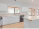 Modern kitchen with white cabinets, black appliances & island at 29759 N Desert Angel Dr, San Tan Valley, AZ 85143