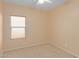 Small bedroom with window and ceiling fan at 29759 N Desert Angel Dr, San Tan Valley, AZ 85143